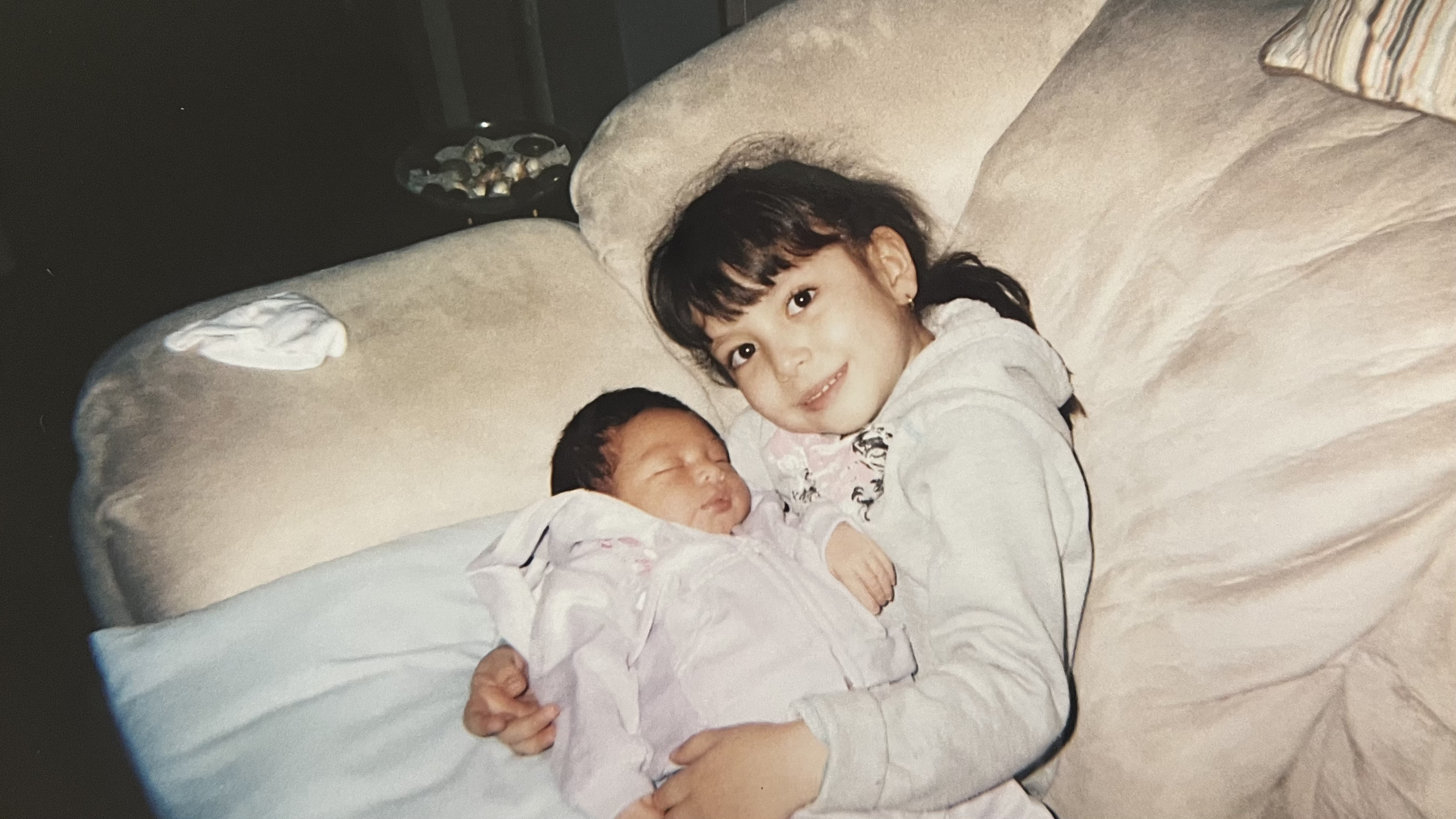 Childhood photo holding a baby